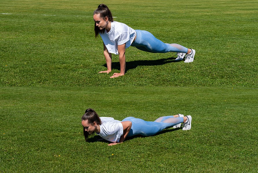 Tytt� treenaa ulkona ja tekee kapeita punnerruksia.